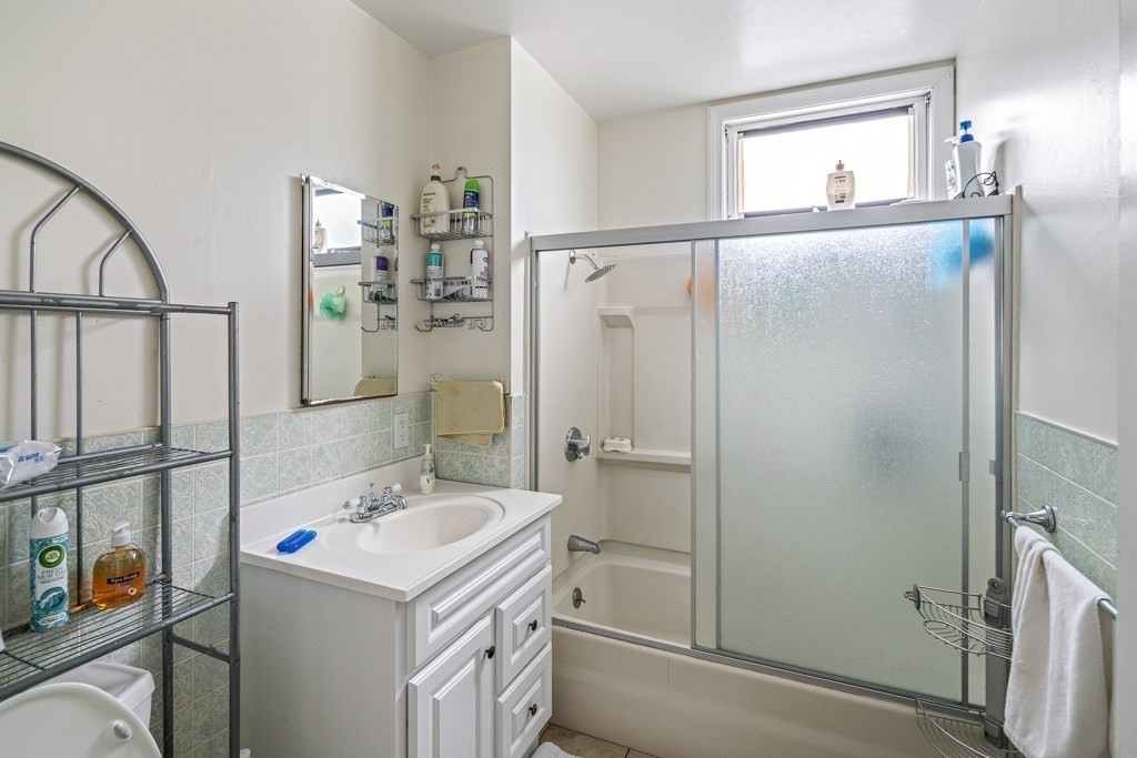 105 Walnut Street Somerville, MA 02145 - Photo 31 of 37 a bathroom with a sink mirror and a shower