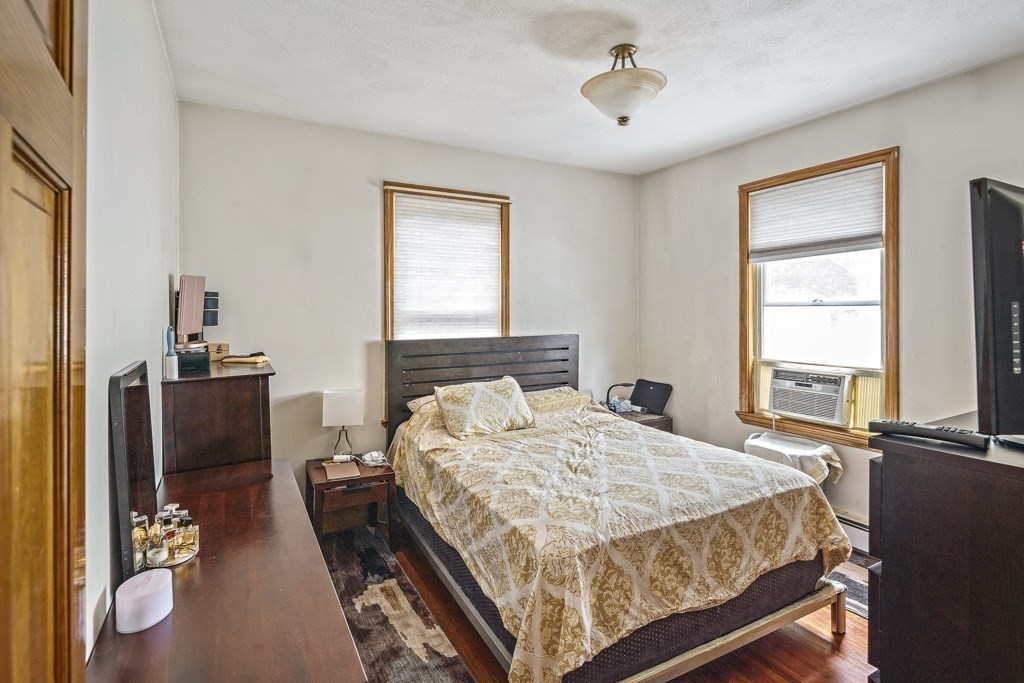 105 Walnut Street Somerville, MA 02145 - Photo 6 of 37 a bedroom with a bed and a window