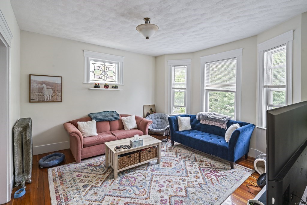 105 Walnut Street Somerville, MA 02145 - Photo 10 of 37 a living room with furniture and a window