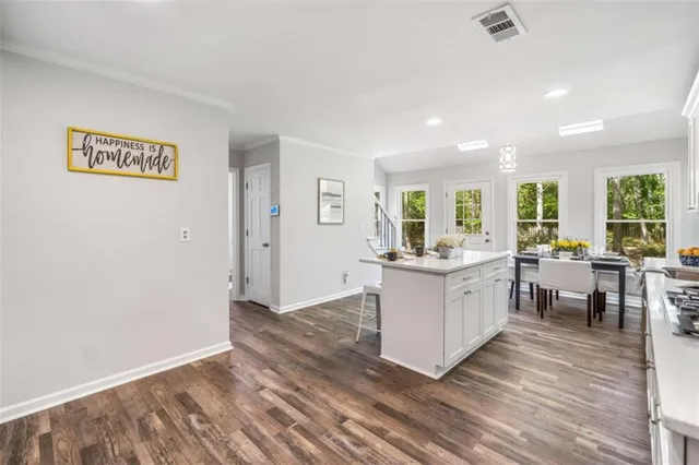 a kitchen with a sink dishwasher a stove and a refrigerator with wooden floor