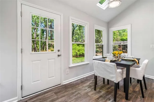 a view of a dining room with furniture wooden floor and a rug