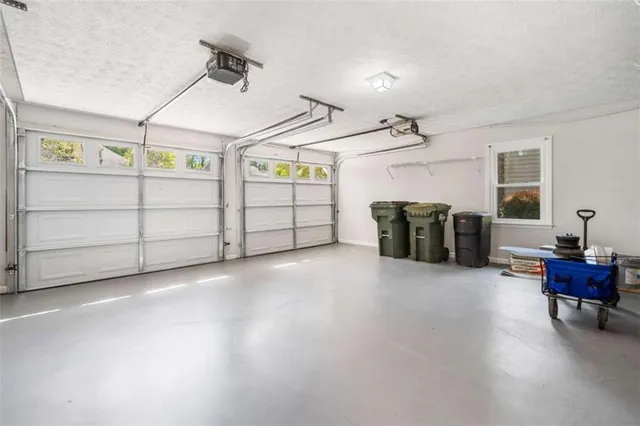 a bedroom with furniture and a large window