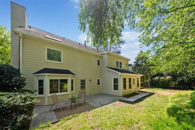 a view of a yard with plants and trees