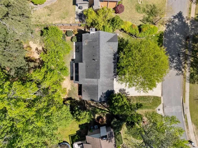 an aerial view of a house with a yard