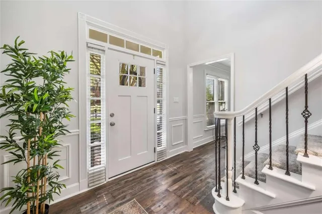 a living room with furniture a rug and a window