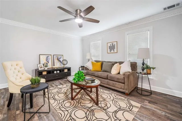 a living room with furniture and a wooden floor
