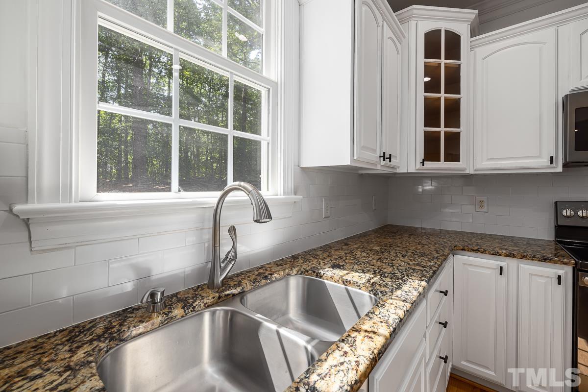 11615 John Allen Road Raleigh, NC 27614 - Photo 17 of 29 a kitchen with granite countertop a sink and a window