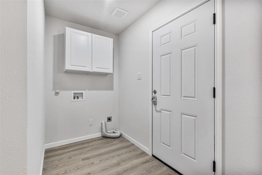 1009 North Barrett Avenue Denison, TX 75020 - Photo 22 of 38 an empty room with wooden floor