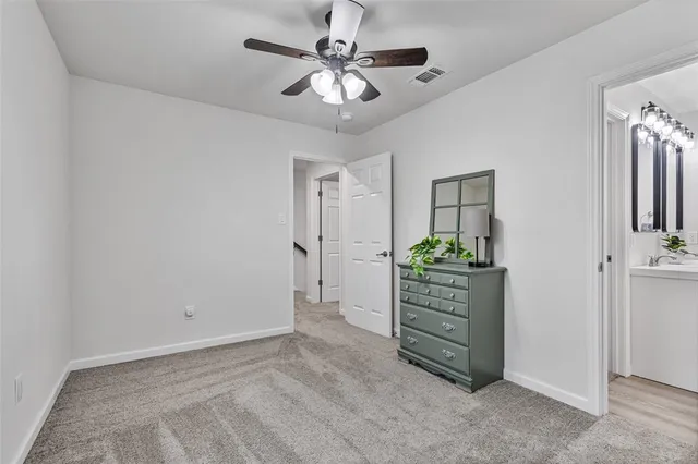a view of a hallway with closet and cabinet