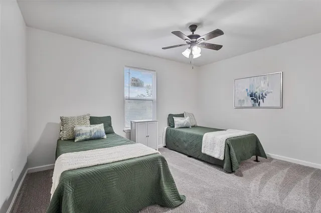 a bedroom with two beds and a chandelier