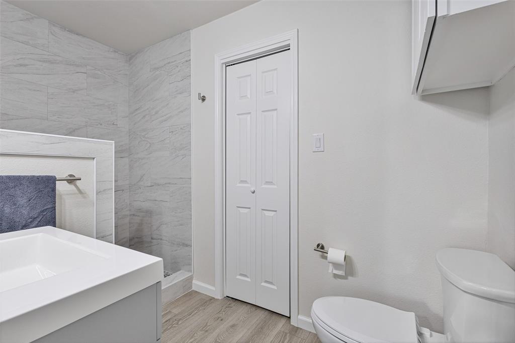 1009 North Barrett Avenue Denison, TX 75020 - Photo 35 of 38 a bathroom with a sink a toilet and shower