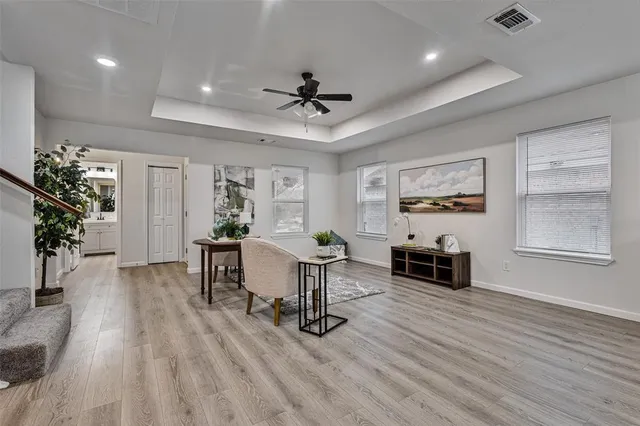 a living room with furniture and a potted plant