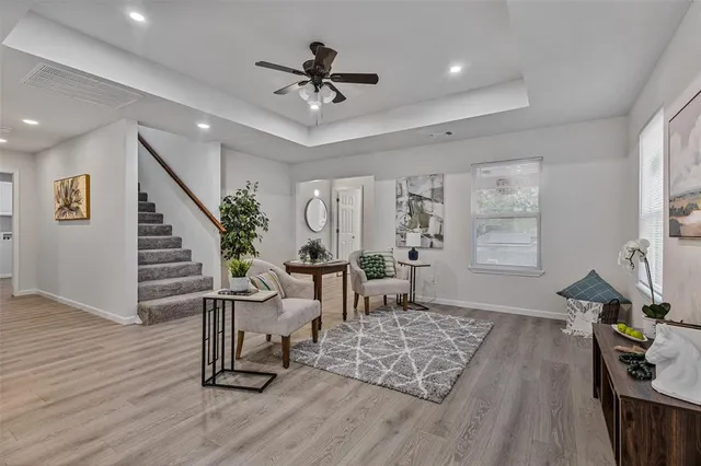 a living room with furniture and wooden floor