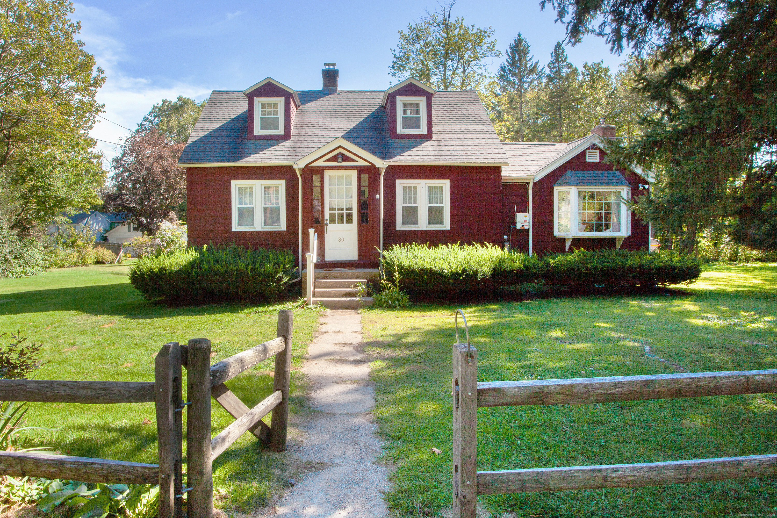 80 Walnut Hill Road East Hartland, CT 06027 - Photo 1 of 33 a front view of a house with a yard table and chairs
