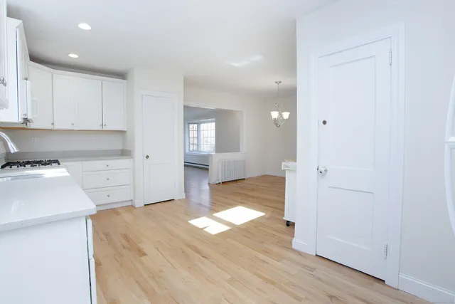 a view of a kitchen with wooden floor