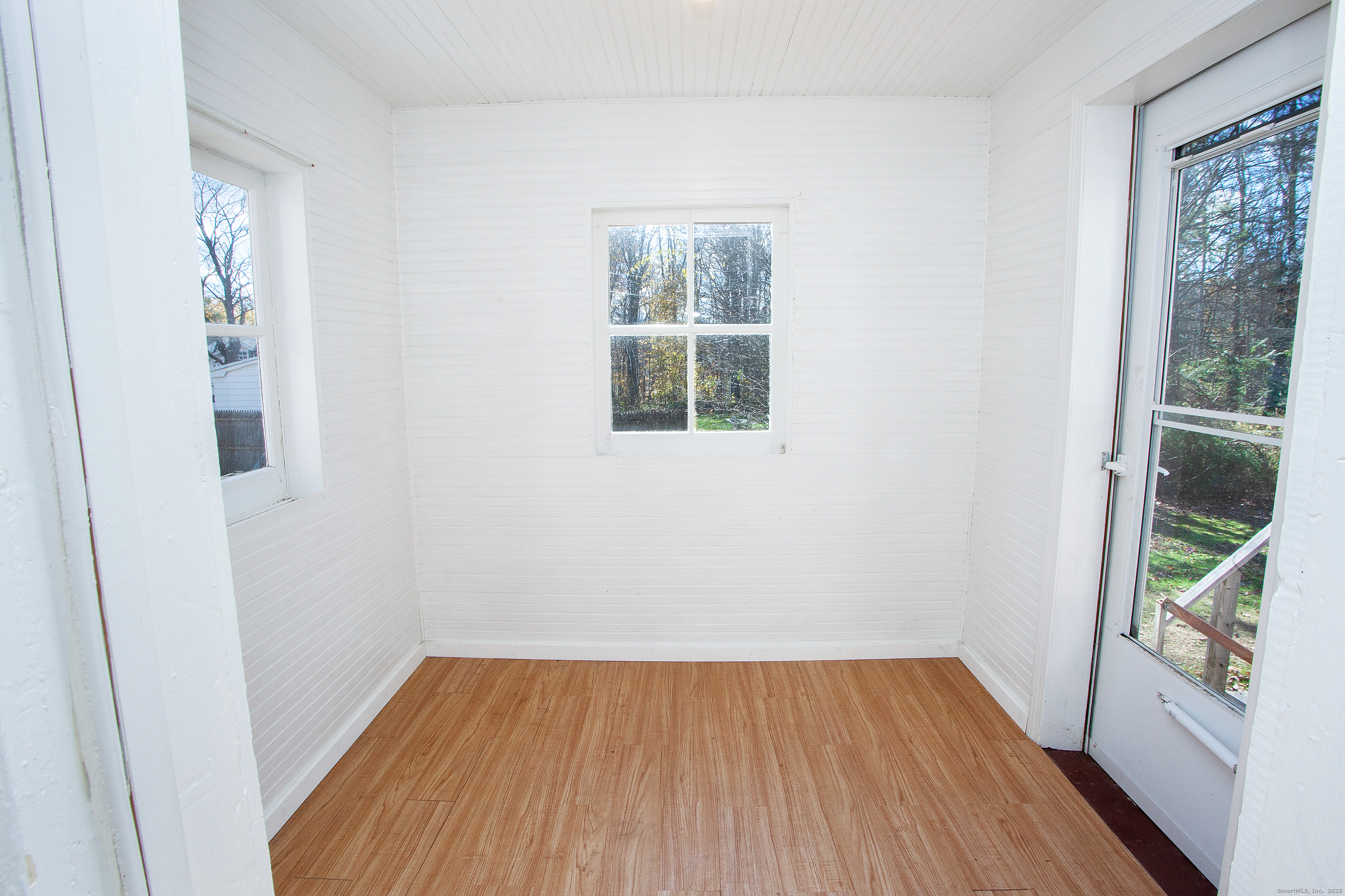 80 Walnut Hill Road East Hartland, CT 06027 - Photo 13 of 33 an empty room with wooden floor and windows