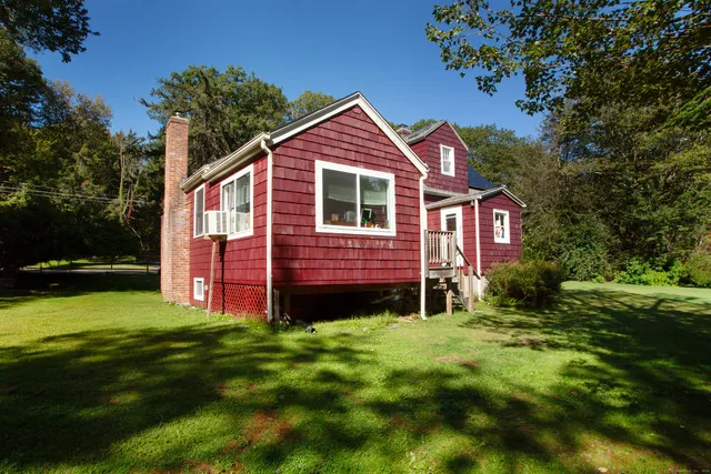 a front view of a house with yard and green space
