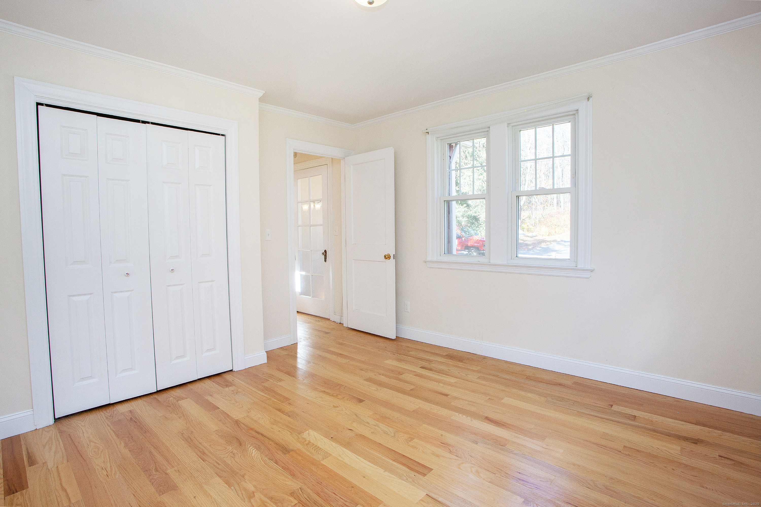 80 Walnut Hill Road East Hartland, CT 06027 - Photo 21 of 33 an empty room with wooden floor and windows