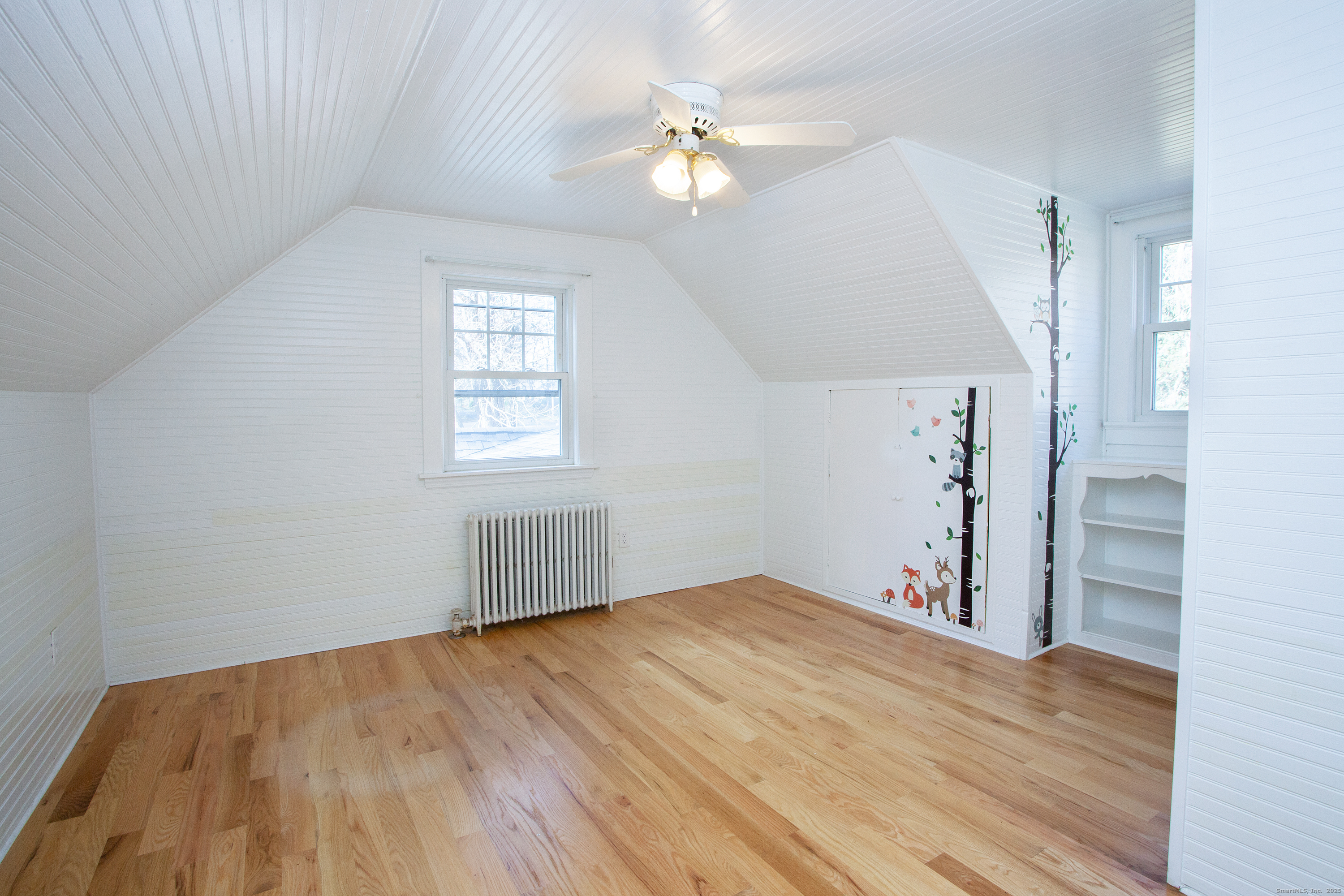 80 Walnut Hill Road East Hartland, CT 06027 - Photo 30 of 33 an empty room with wooden floor chandelier fan and windows