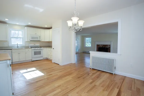 a view of a kitchen with wooden floor and a kitchen