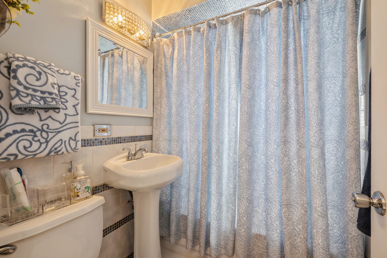 3922 West 85th Place Chicago, IL 60652 - Photo 11 of 17 a bathroom with a sink a mirror and a shower curtain