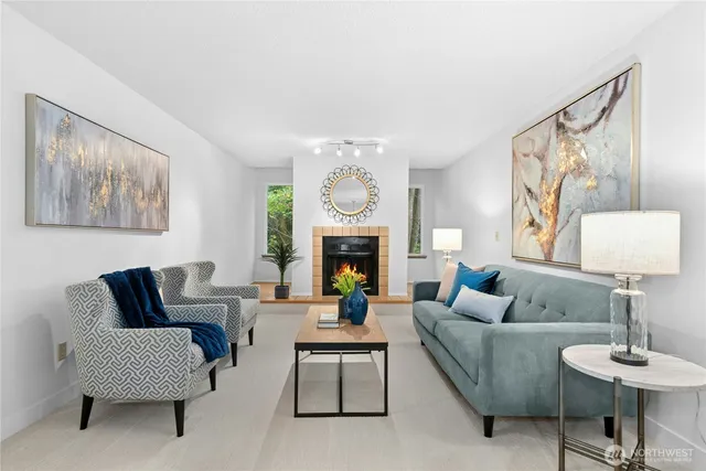 a living room with furniture a fireplace and a large mirror