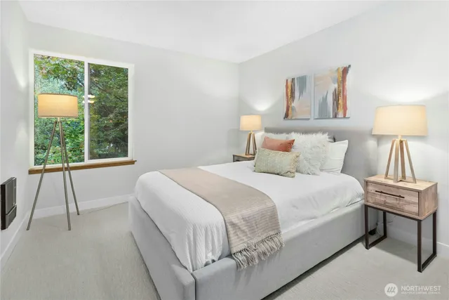 a bedroom with a bed and a window