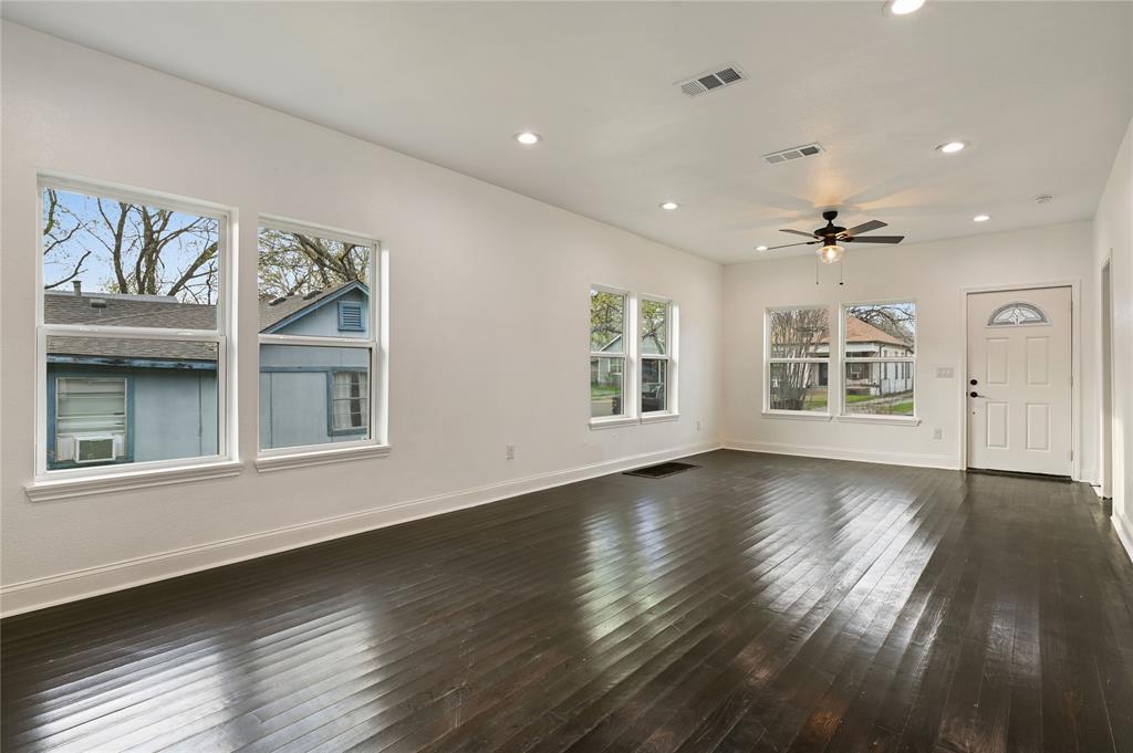 1106 West Chestnut Street Denison, TX 75020 - Photo 17 of 38 Unfurnished living room with ceiling fan and dark wood-type flooring