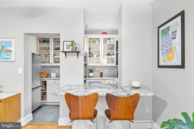 a dining room with furniture and a window