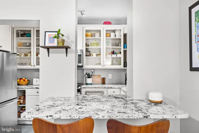 a living room with granite countertop furniture and a wooden floor