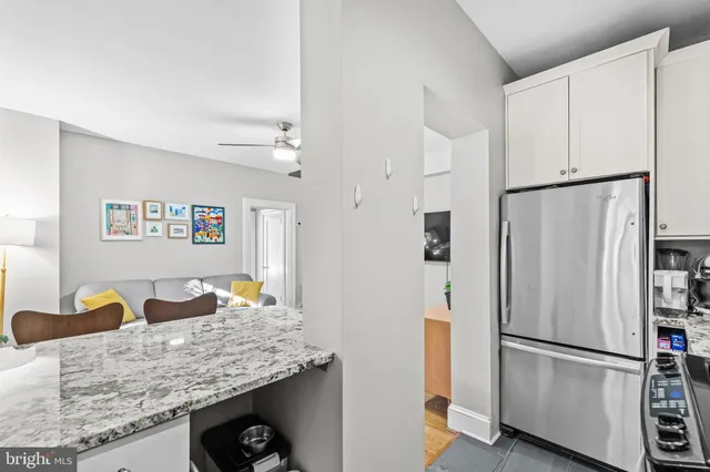 a kitchen with stainless steel appliances granite countertop a refrigerator and a stove top oven