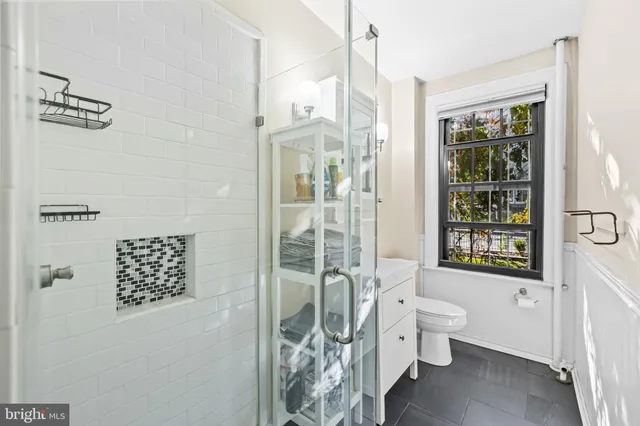 a bathroom with a toilet a sink and a shower