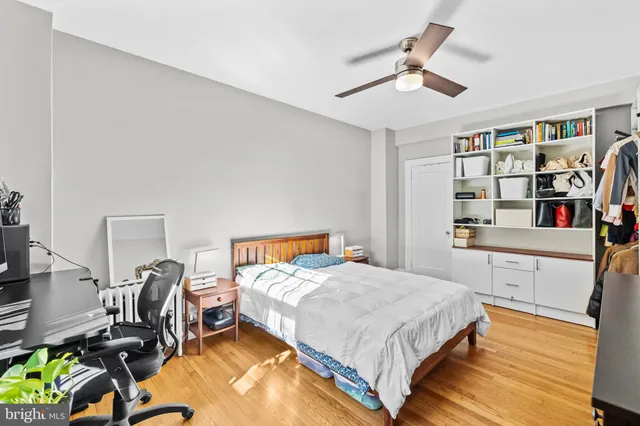 a bedroom with a bed furniture and a book shelf