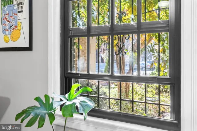 a vase of flowers sitting on a table next to a window
