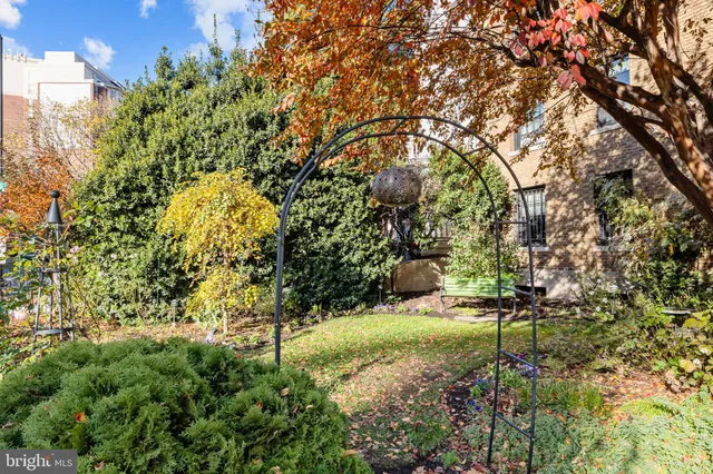 a backyard of a house with a yard and outdoor seating