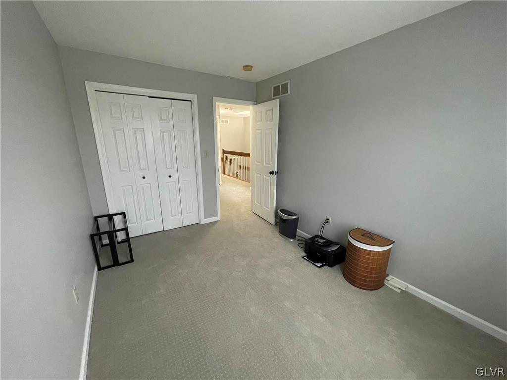 1668 Harding Circle Whitehall, PA 18052 - Photo 23 of 32 a room with a chair and a ceiling fan