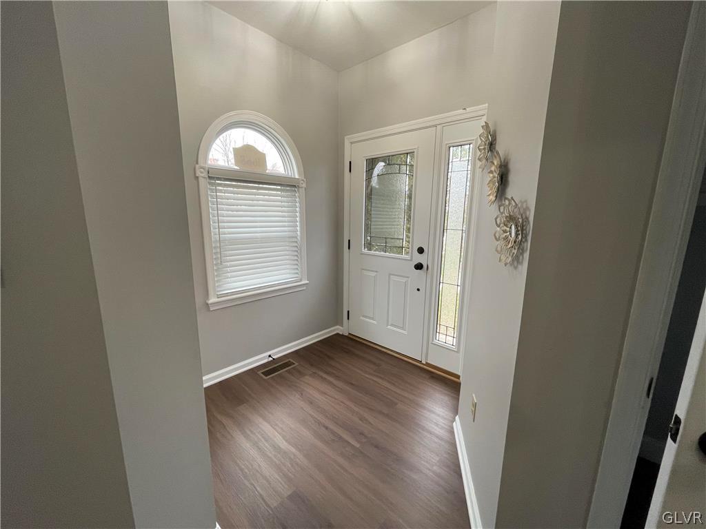 1668 Harding Circle Whitehall, PA 18052 - Photo 3 of 32 an empty room with wooden floor cabinet and windows