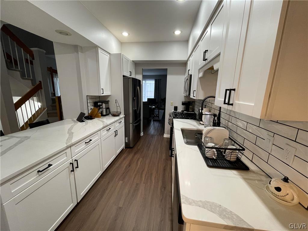 1668 Harding Circle Whitehall, PA 18052 - Photo 6 of 32 a large white kitchen with stainless steel appliances