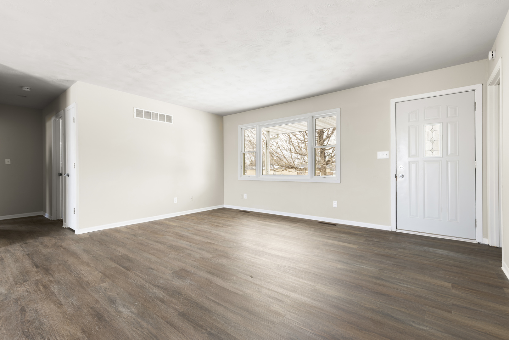Undisclosed Address Davis, IL 61019 - Photo 3 of 21 an empty room with wooden floor and windows