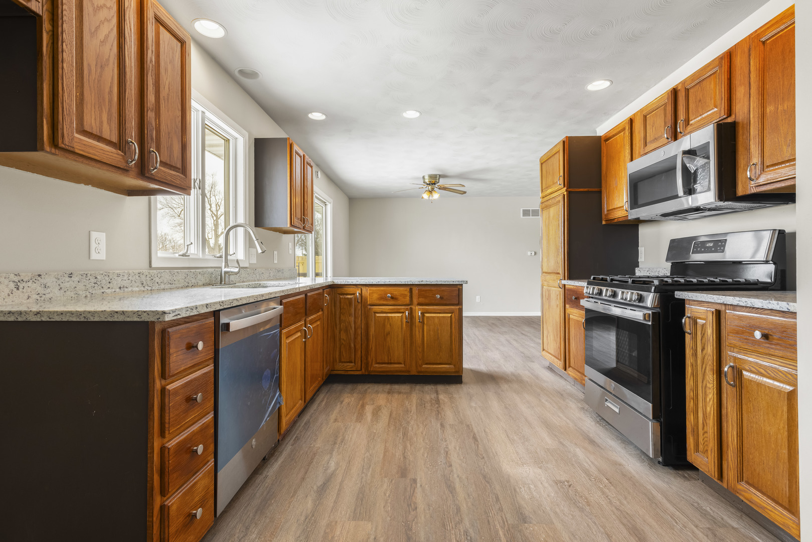 Undisclosed Address Davis, IL 61019 - Photo 4 of 21 a kitchen with stainless steel appliances granite countertop a stove a sink and a refrigerator