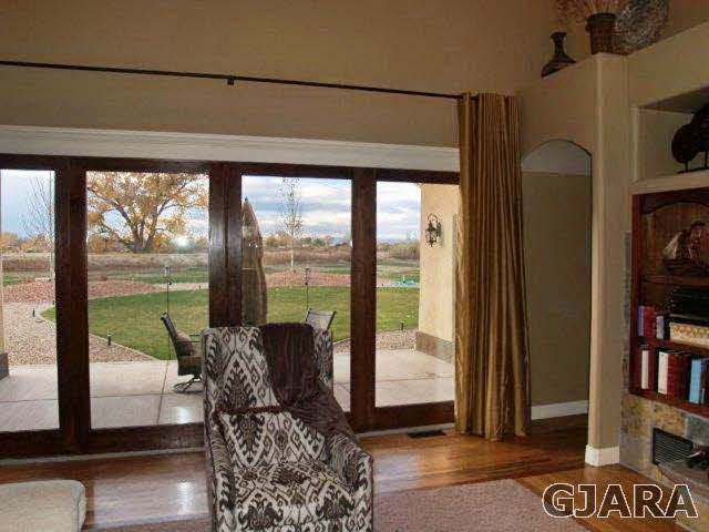 815 Mease Road Grand Junction, CO 81505 - Photo 21 of 42 a living room with furniture and a floor to ceiling window