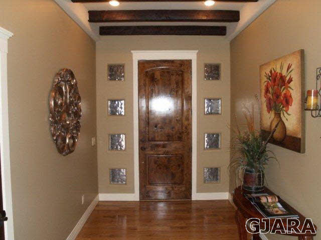 815 Mease Road Grand Junction, CO 81505 - Photo 4 of 42 a view of a hallway with wooden floor and a potted plant