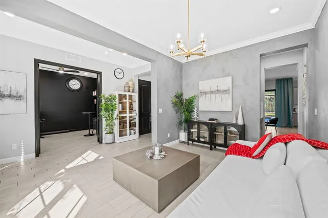 a bedroom with a bed and a chandelier