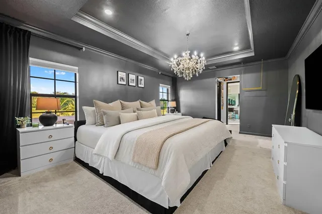 a bedroom with furniture and a flat screen tv