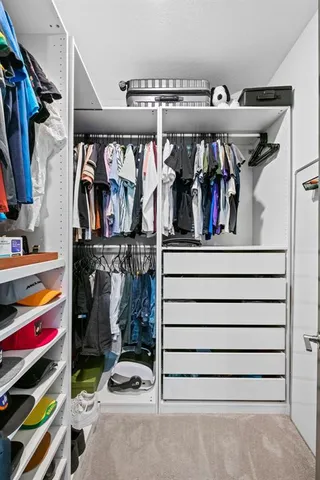 a bathroom with a sink a toilet a mirror and shower