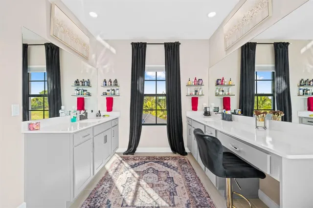 a bathroom with double vanity and a mirror