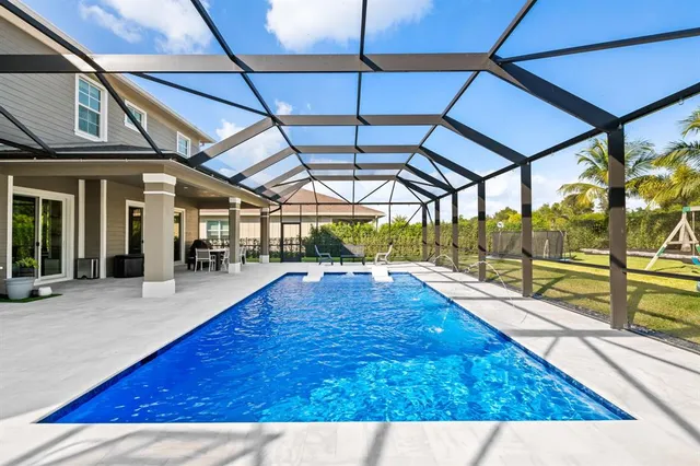 a kitchen with stainless steel appliances kitchen island granite countertop a sink and white cabinets