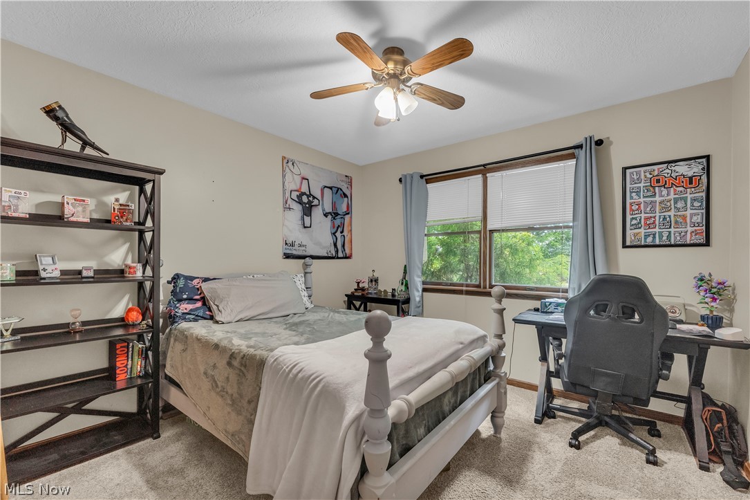 408 River Road Canal Fulton, OH 44614 - Photo 26 of 42 Bedroom featuring neutral-toned walls, textured carpeting, a multi-pane window with blinds, and a ceiling fan with integrated lighting