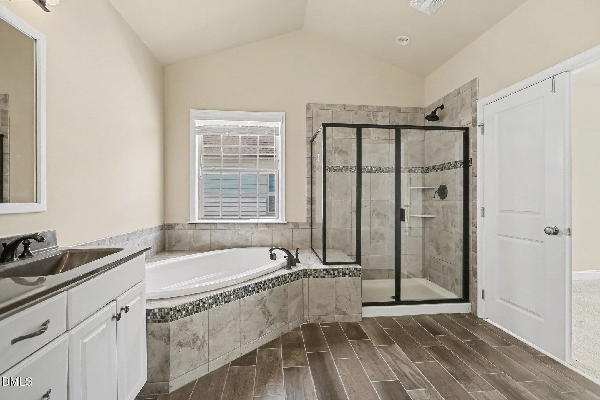 351 Gartrell Way Cary, NC 27519 - Photo 36 of 51 a bathroom with a tub a sink and a window