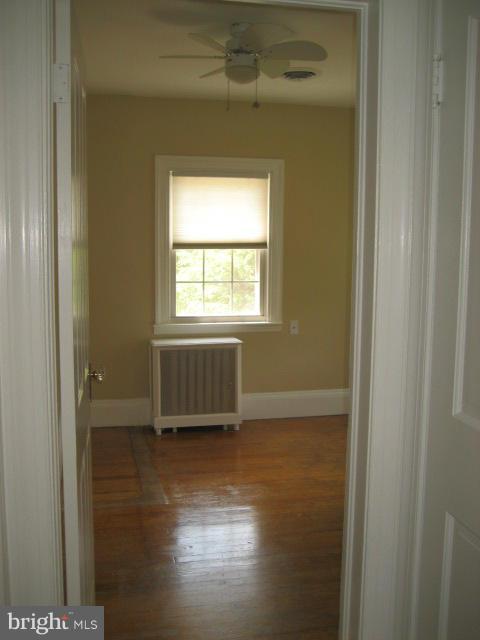 25 Normal Terrace Towson, MD 21286 - Photo 14 of 20 a view of an empty room with wooden floor and a window